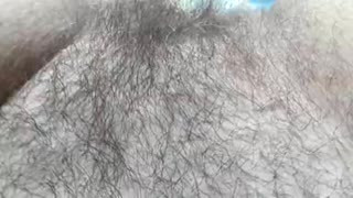 Hairy mature flashing in front of window