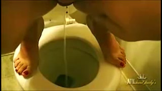 Marisa Vazquez pees in the bathroom.