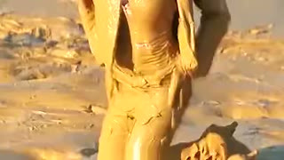 Brunette getting muddy in jeans