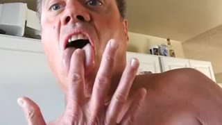 Naked mature man peeing in sink.