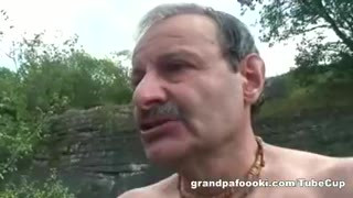 Superb babe rides grandpa's cock in nature